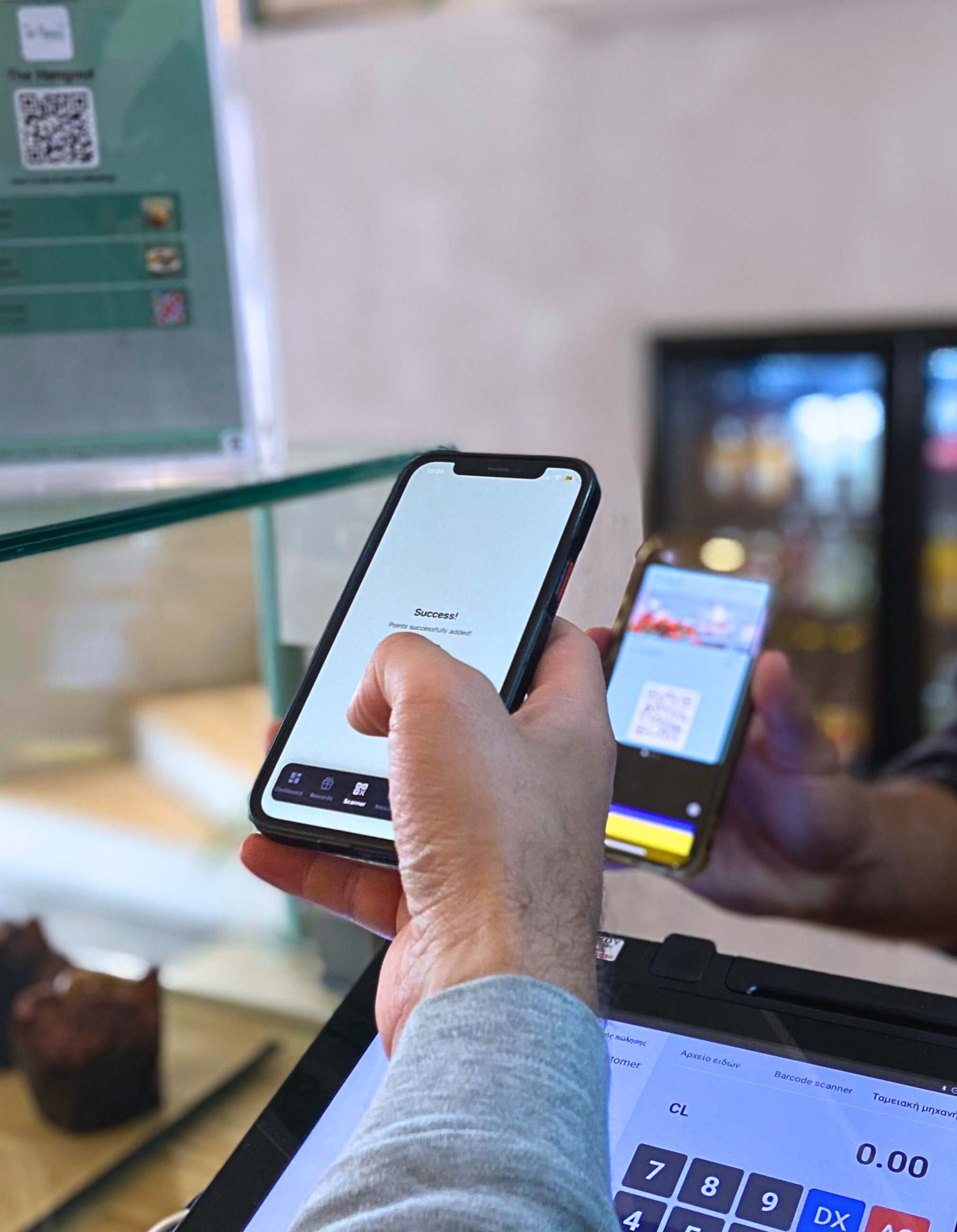 A team member scans a guest’s digital loyalty card at the checkout.